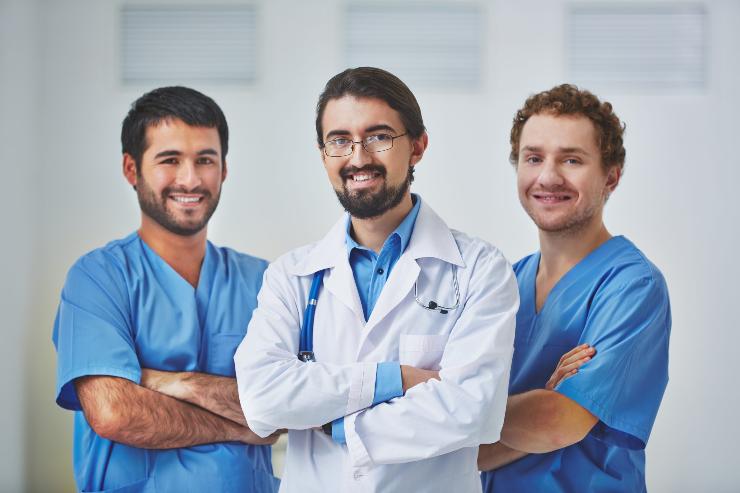 Portrait of three clinicians in uniform looking at camera