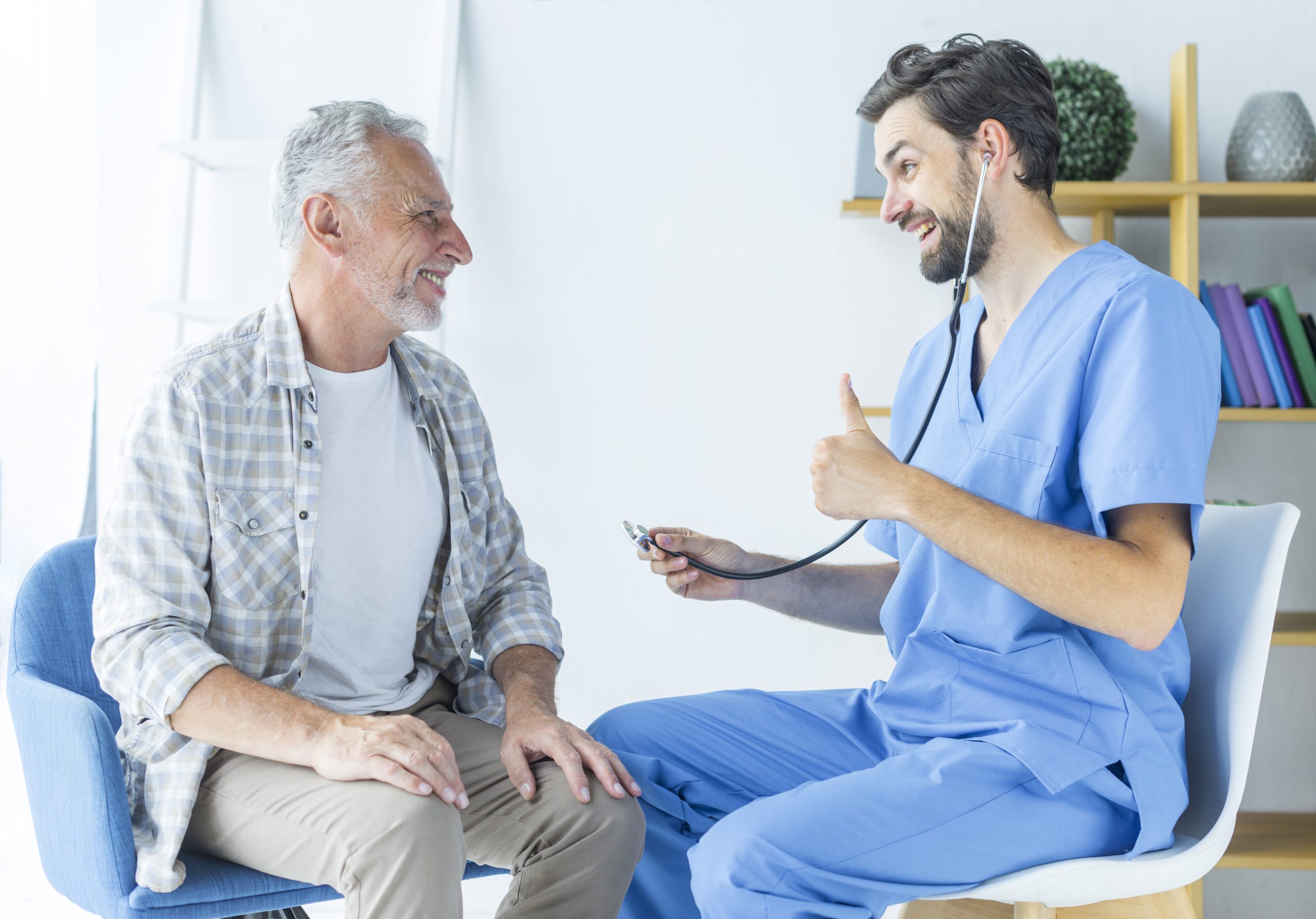 young-doctor-gesturing-thumb-up-elderly-patient